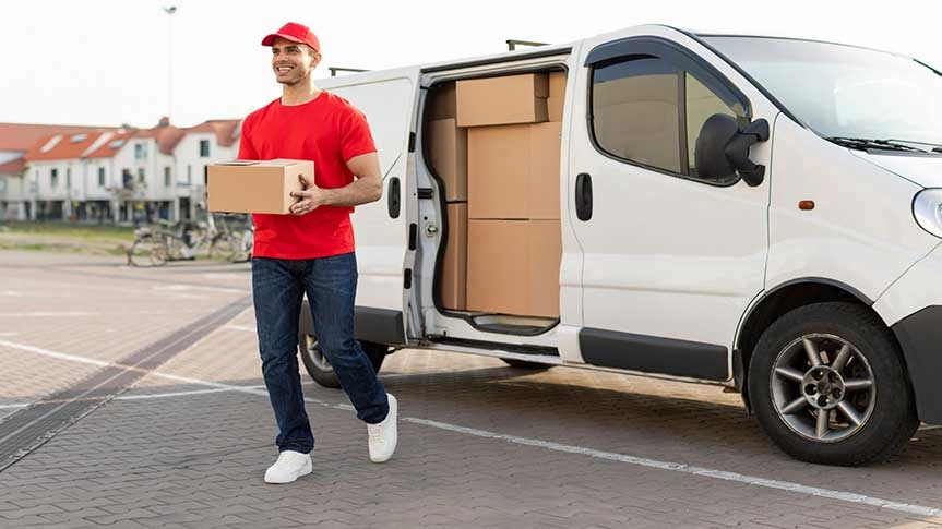 Courier holding a package beside a delivery van, representing scheduled delivery and time-controlled courier service operations