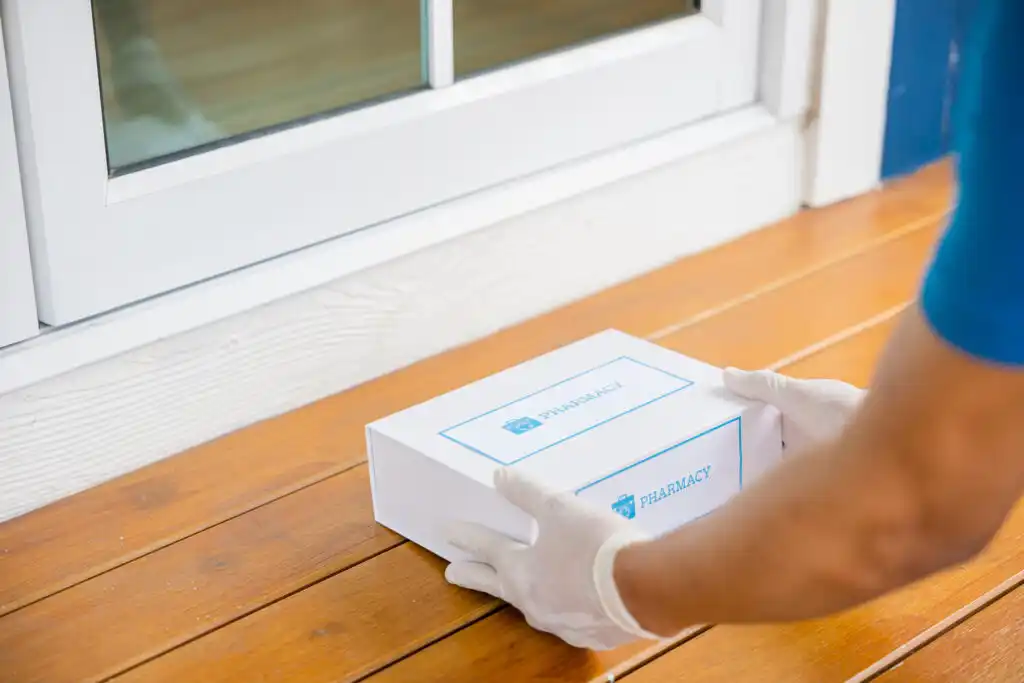 Medical courier delivering a pharmacy package to a doorstep, illustrating how to become a medical courier.