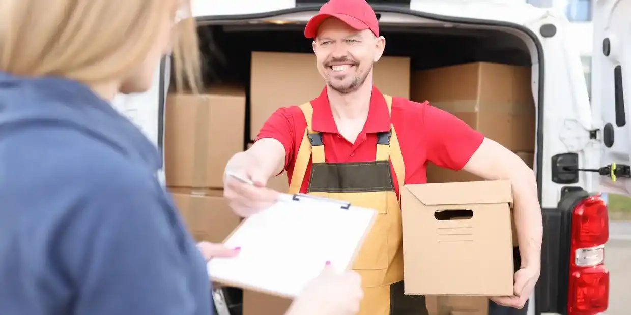 Courier delivery vehicle on the road with packages, showing tracking status “Out for Delivery” – illustrating what does out for delivery mean.