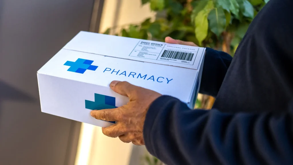A Complete Guide to Shipping Pharmaceuticals – A person delivering a securely packaged pharmacy box containing pharmaceutical products, highlighting safe handling and regulated medical shipping.